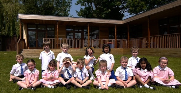 new school intake sitting outside their eco-classroom new school intake sitting outside their eco-classroom